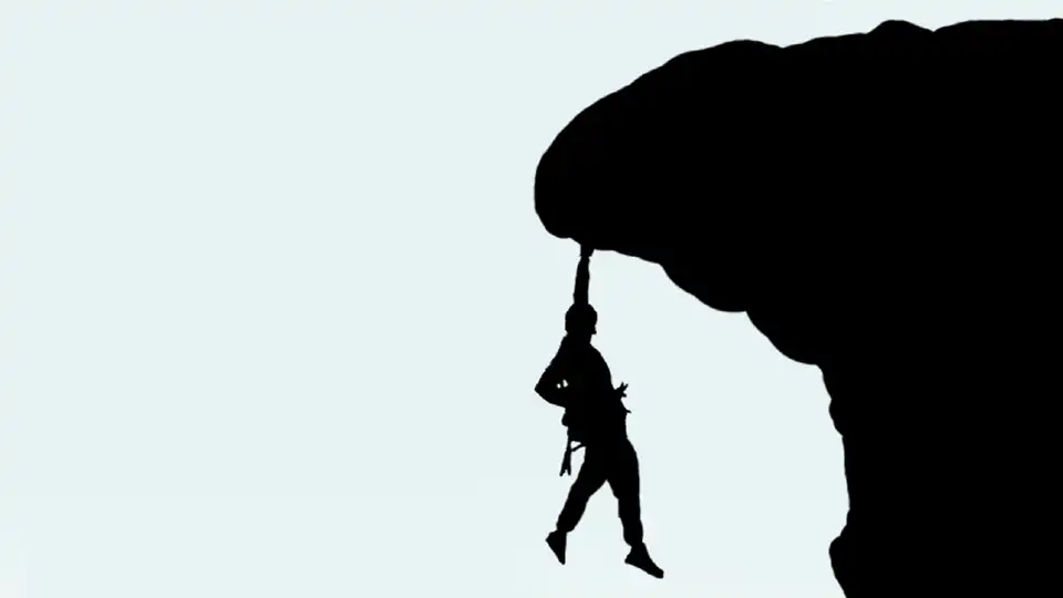 person hanging from cliff